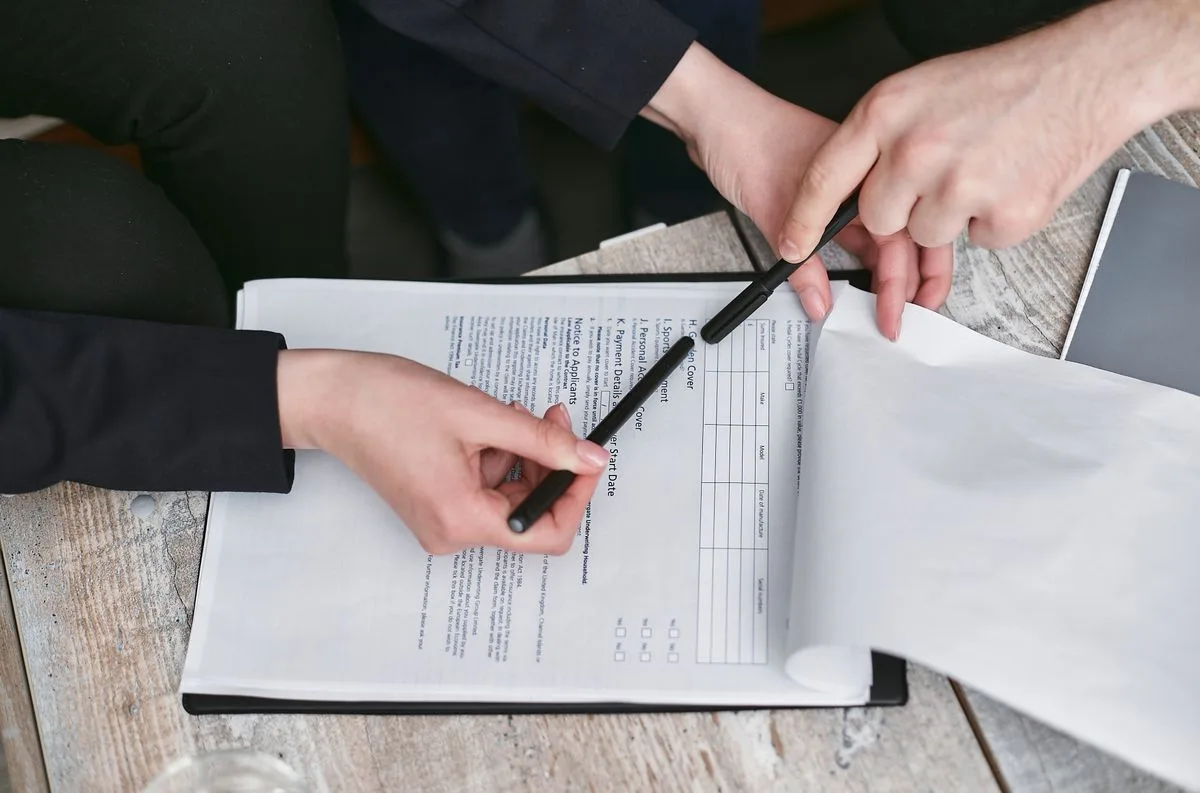 Business partners reviewing legal documents in an office setting