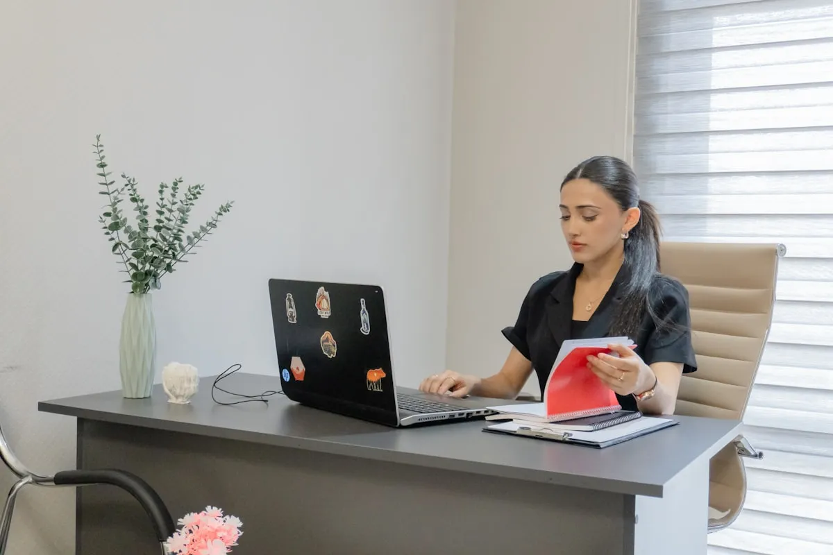 Professional reviewing licensing documents at a modern office desk