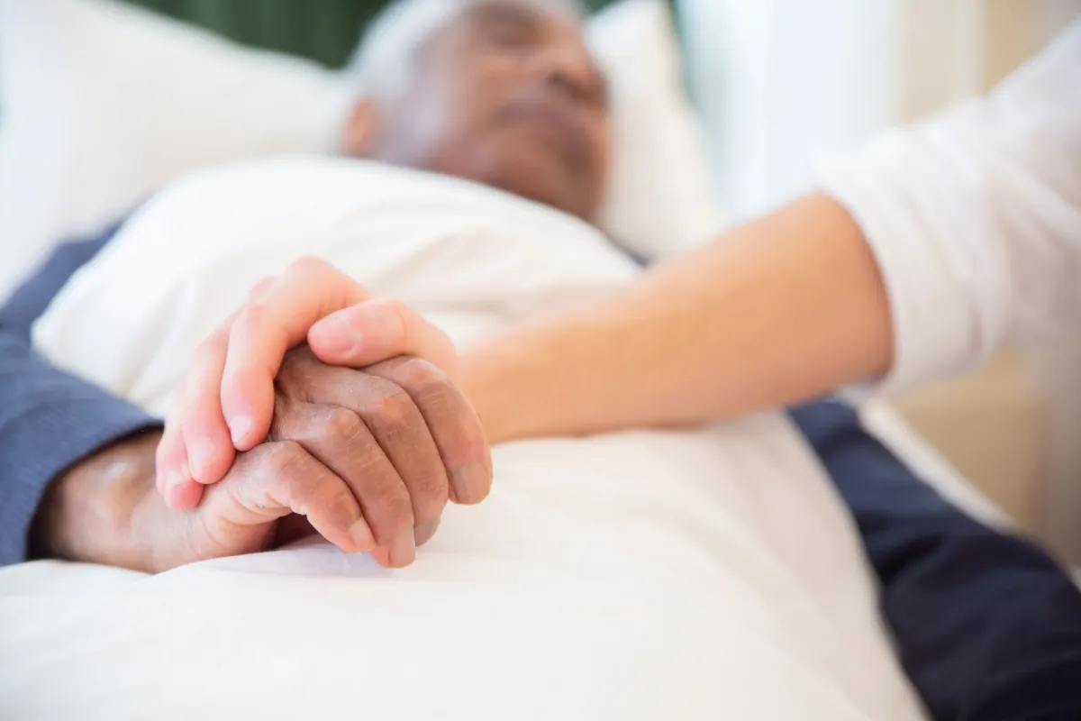 Compassionate hospice care with family holding hands