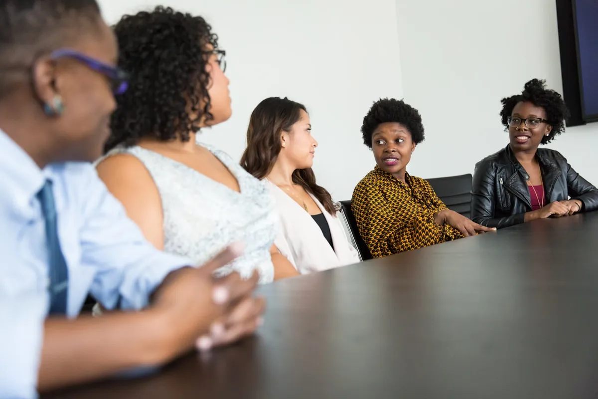 Family members in serious conversation around a conference table during estate planning