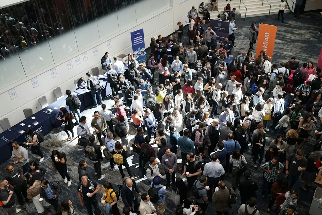 Professional convention expo floor with attendees networking at trade show booths