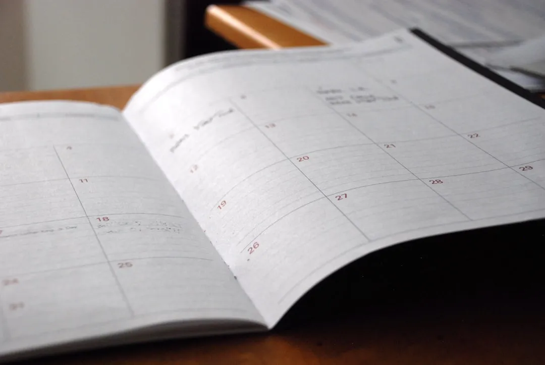 Professional desk planner with organized tax documents and filing calendar