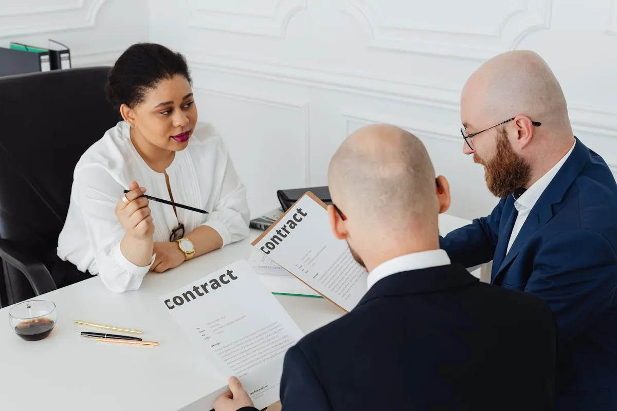 Business professionals reviewing legal documents and contracts in an office setting