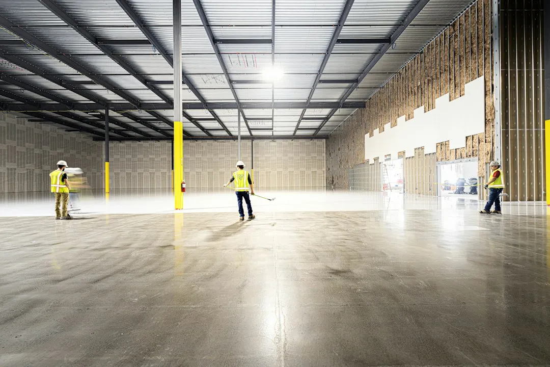 Inspector with clipboard walking through a commercial building during a facility audit