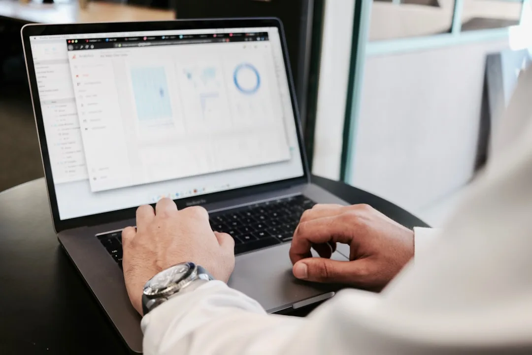 Person analyzing software dashboard on a laptop screen at a professional desk