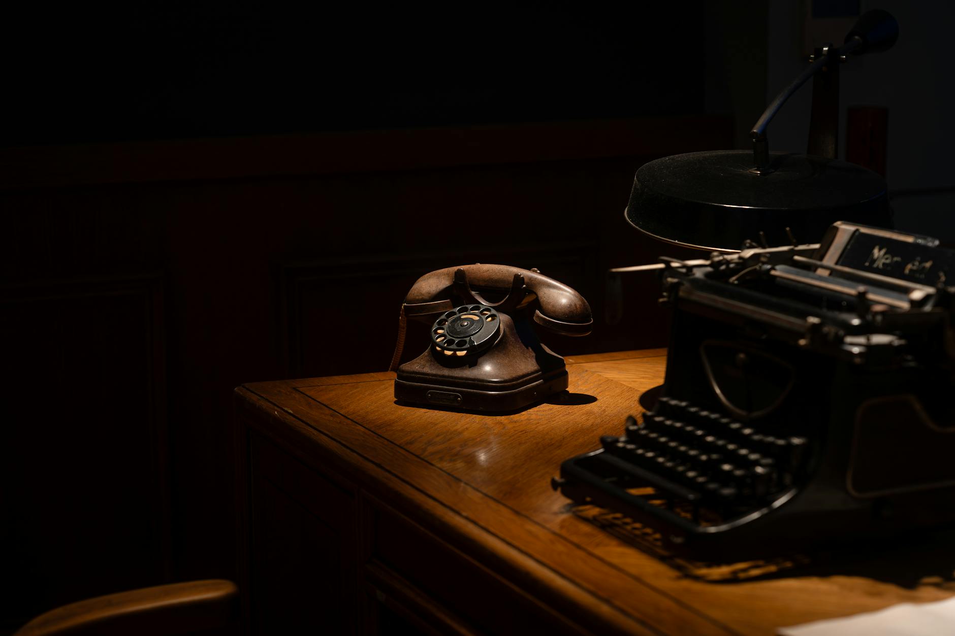 Funeral home office desk with phone in dim after-hours lighting