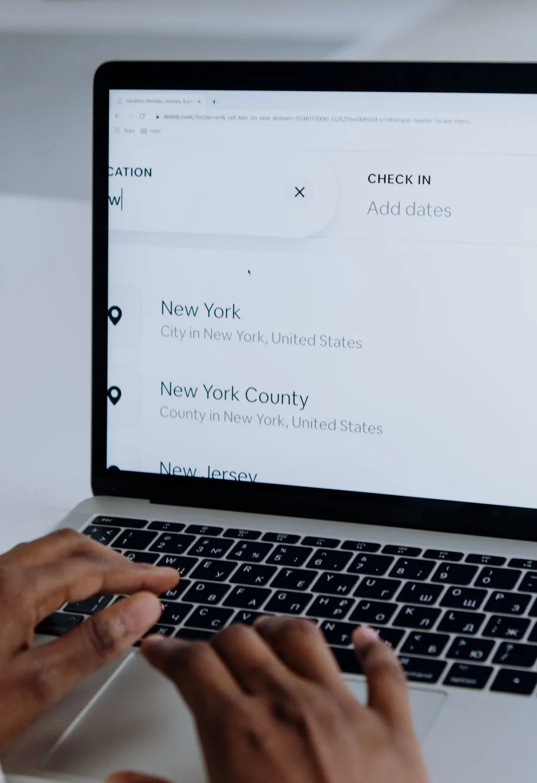 Person searching government database records on a laptop in a professional setting