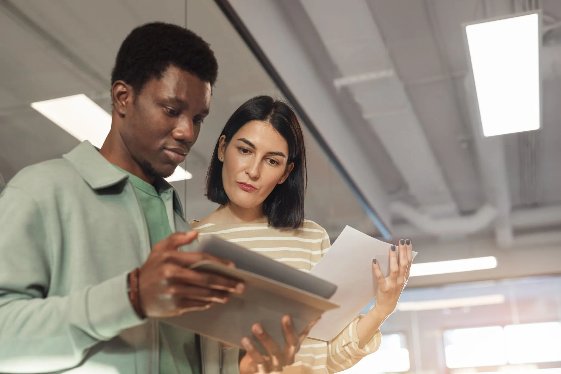 Professional reviewing financial documents and revenue projections on a tablet