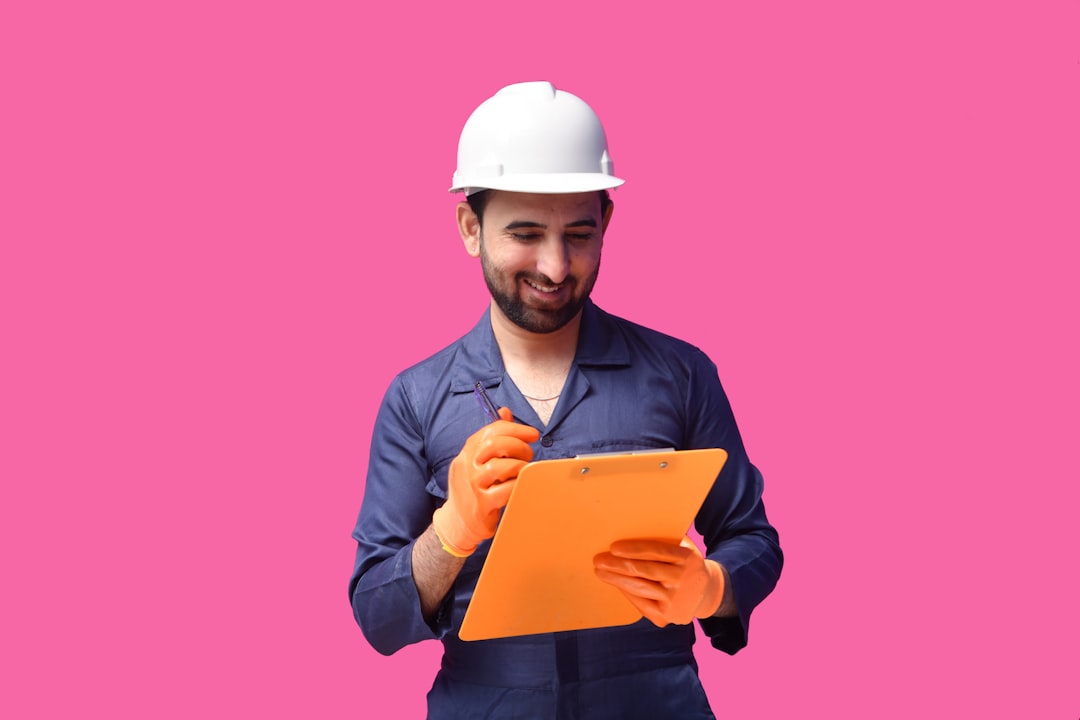 Professional conducting a building inspection with clipboard in warm daylight