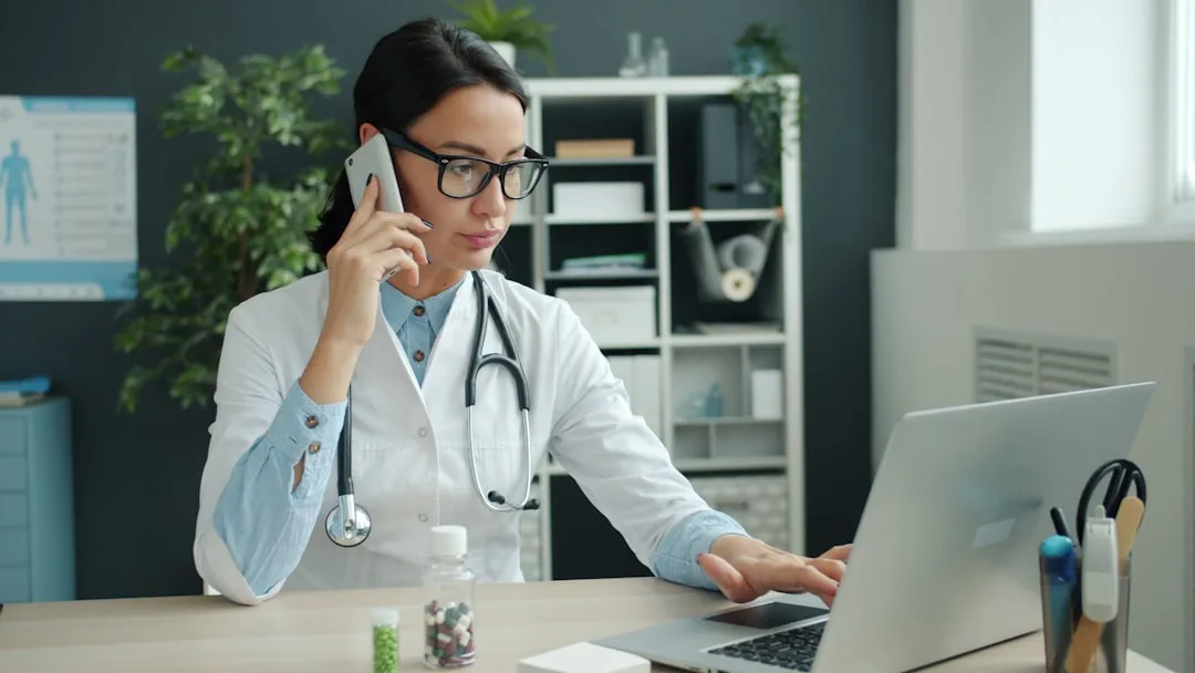 Medical professional working on laptop computer system