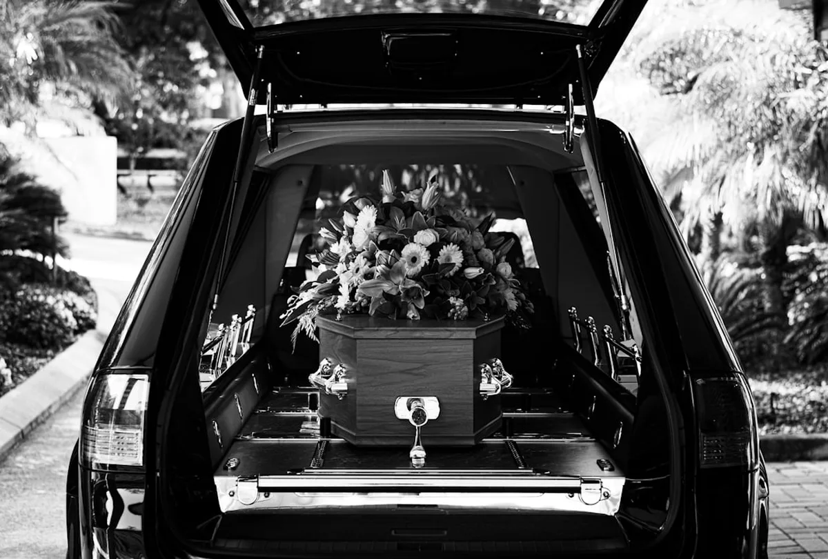 Professional funeral fleet vehicles parked at a facility