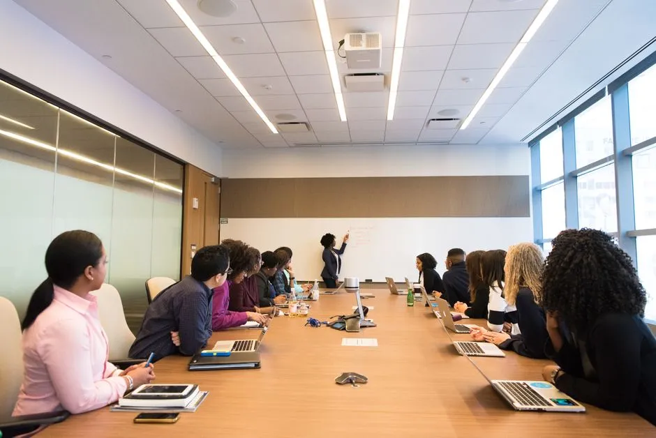 Professional staff meeting in conference room discussing worker classification