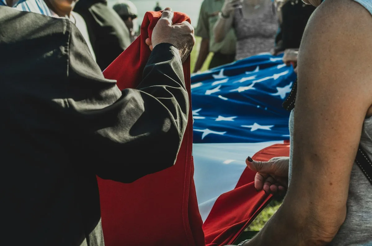 Military honor guard performing flag ceremony at a veterans memorial service