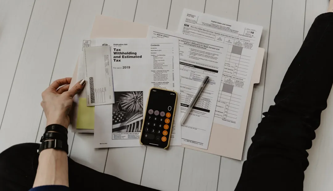 Professional reviewing financial statements and audit paperwork in an office setting