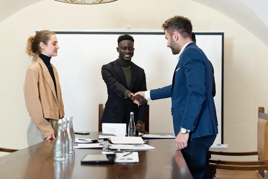 Business professionals negotiating at a conference table with financial documents